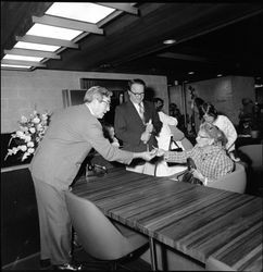 Harold "Hal" Trebbe talking to customers at the grand opening of the Bank of Sonoma County, Santa Rosa, California, September 18, 1965