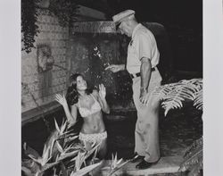 Sheriff and bikini-clad girl at the Hall of Flowers at the Sonoma County Fair, Santa Rosa, California, 1972