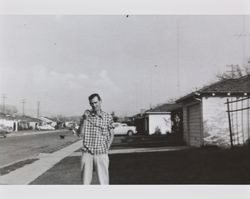 William K. McGregor smoking a pipe in the front yard of an unidentified house, Santa Rosa, California, about 1957