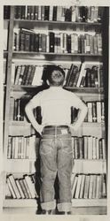 Tommy Scott searching book shelves of Petaluma Carnegie Library, 20 Fourth Street, Petaluma, California, October 8, 1962