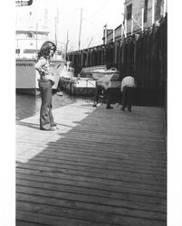 People on the floating dock beneath the Petaluma and Santa Rosa Railroad at the Turning Basin