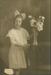 Portrait of an unidentified girl with a vase of roses