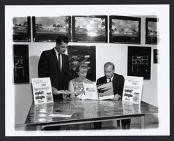 Looking at brochures and plans at Young America's Oak Lake Green subdivision, Petaluma, California, 1964