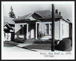 Simple truncated hip roof cottage with center gable and bracketed cornice