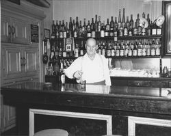 Man mixing drinks in an unidentified Petaluma, California bar, 1953