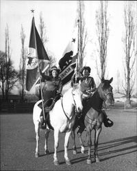 Two members of the color guard of the California Centaurs mounted junior drill team at the Sonoma County Fairgrounds in Santa Rosa, California, 1947