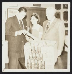 Ronald Reagan receiving an apple from an unidentified apple princess