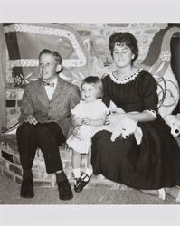 Bill, Bonnie, and Janet Alwes sitting in front of a brick fireplace, San Rafael, California, 1962