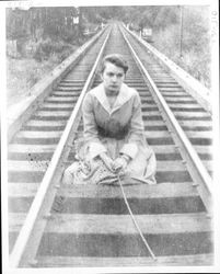 Dosola Paladini Bartolomei sitting on the railroad tracks