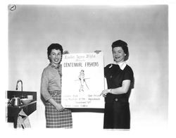 Two women holding placard that reads "Epsilon Sigma Alpha presents centennial fashions", Petaluma, California, 1958