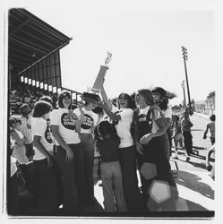 Bank of Marin goat milking team hold up their first place trophy on Farmers' Day at the Sonoma-Marin Fair, Petaluma, California, 1978