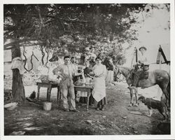 Family making sausage in the backyard