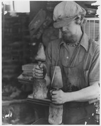 Foundry worker holding casting tools at an unidentified foundry, 1970s