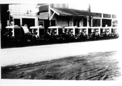 Tractors parked in front of Lampson's Garage