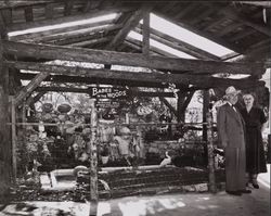 Ollie Bockee and an unidentified man standing in front of the Babes in the Wood Wishing Well, Calistoga, California, about 1948