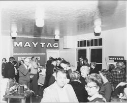 People talking and drinking under the Maytag sign at The Washing Machine Man open house, Santa Rosa, California, 1965