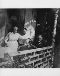 Martha Ellen Tupper Evans with her son, Mervyn Roy Evans, and her husband, E. W. M. Evans seated on the porch of the family home at 210 West Street, Petaluma, California, about 1924