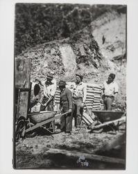 Workers loading wheelbarrows with concrete on the site of reconstruction of St. Elizabeth's, Guerneville, California, 1935