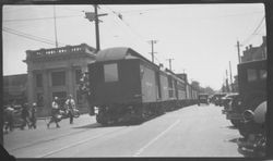 Last train from Forestville to Sebastopol hauling passenger cars to Petaluma on Main Street, Sebastopol, 1931