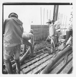 Construction workers pumping concrete into forms for the second floor in the new Exchange Bank building, 545 Fourth Street, Santa Rosa, California, 1971