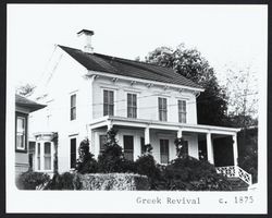 Bracketed two story cottage with Greek Revival elements