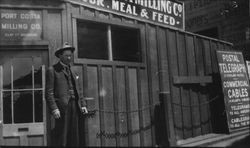 Unidentified man in front of the Port Costa Milling Company Clay Street bulkhead, San Francisco, California, about 1910