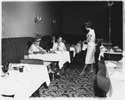 White calf-length dress modeled in the "Dramatic Moods" fashion show in the Topaz Room, Santa Rosa, California, 1959