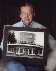 Milton Earl Lund with a photo of his restaurant, Petaluma, California, 2007