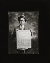 William S. Borba holding Bodega Bay historical landmark plaque, April 22, 1934