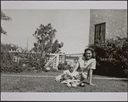 Joan Spolini and June Barber with baby chicks at the Spolini home, 200 Dana Street, Petaluma, California, April 10, 1939