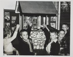 Children with wishing well at Petaluma Carnegie Library, 20 Fourth Street, Petaluma, California, about 1938