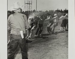 Tug of war on Farmer's Day with bath at the Sonoma County Fair, Santa Rosa, California, 1986