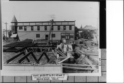 Using hoist to put blocks in place at new post office