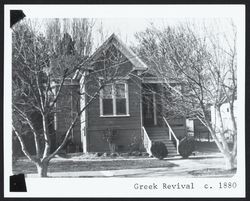 Simple Greek Revival house with Italianate window