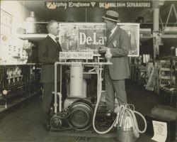 A. F. Tomasini and an unidentified man standing in front of a DeLaval Milker at the A. F. Tomasini Hardware stores, Petaluma, California, 1924