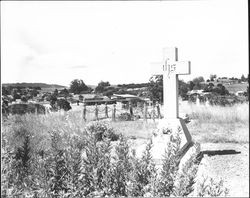View of the tombstone of Reverend Jeremiah Leahy, Calvary Cemetery, and surrounding Petaluma, California, 1960