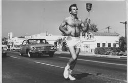 Bill Beffa carrying a torch on Petaluma Boulevard North, Petaluma, California, about 1966