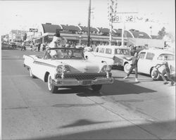 Convertible holding a snowman, Petaluma, California, 1956