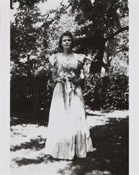 Mary McGregor holding flowers and wearing her school graduation dress, Santa Rosa, California, 1941