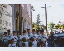 Optimist Little League baseball team standing on Keller Street, Petaluma, California, 1958