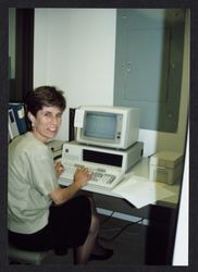 Judith Rousseau at work on romm computer terminal