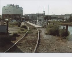 View of Water Street and the Petaluma & Santa Rosa Railroad trestle and tracks, Water Street, Petaluma, California, between 1977 and 1986