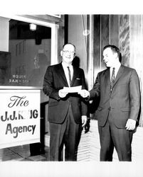 Dave King and unidentified man in front of the J. J. King Agency