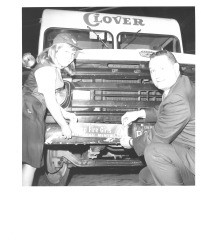 Putting Camp Fire Girls bumper sticker on Clover truck, Petaluma, California, about 1959