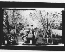 McNear family out for a drive through an orchard, Petaluma, California, about 1910