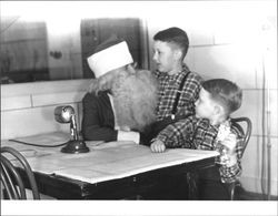 Unidentified Santa speaking with two boys, Petaluma, California, December 1947