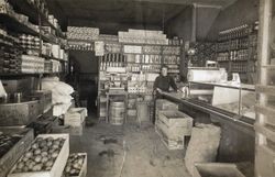 Celestina Paulucci standing inside a market that was located on North Main Street, Petaluma, California, 1910