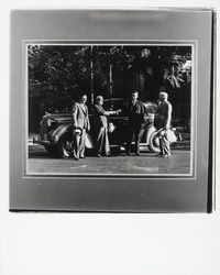 Frank Doyle and 3 men standing next to a car