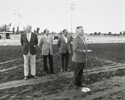 Members of the board and others standing on the race track at the Sonoma County Fairgrounds, July 1975