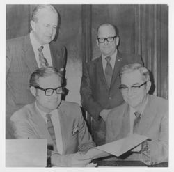 Tom Klinker and others examine a document in Sebastopol, about 1967